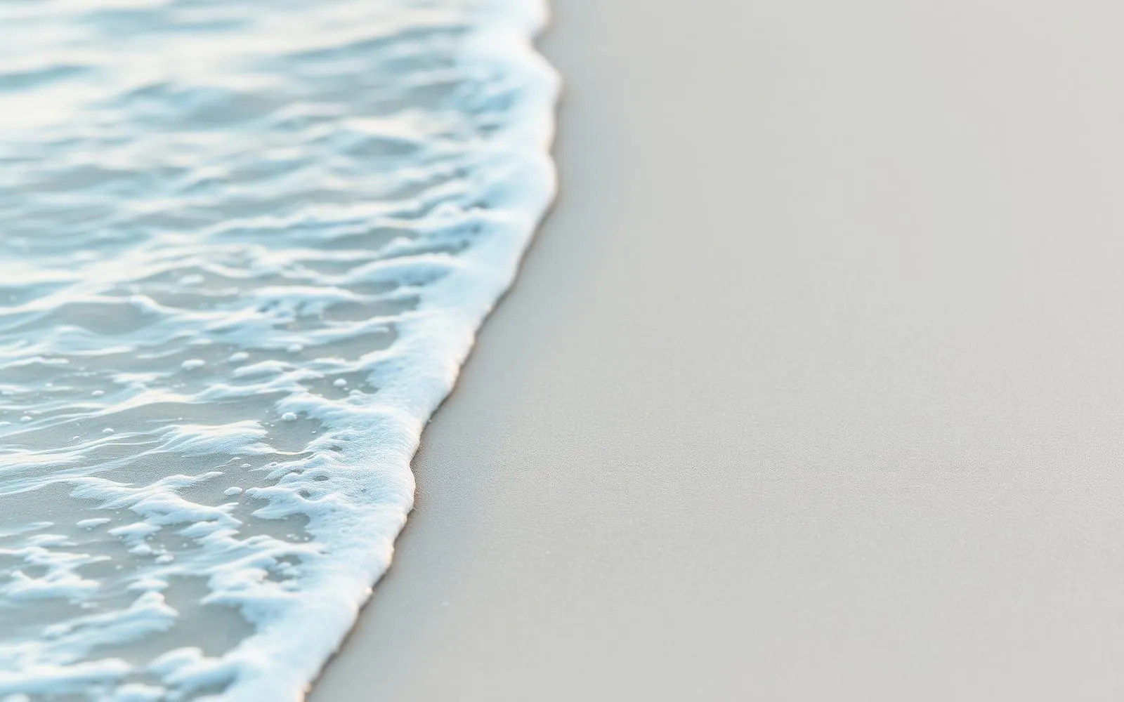 Soft turquoise water meeting white Caribbean sand
